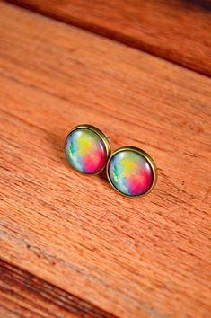 These pastel earrings are beautiful in color! These watercolor earrings are great for those who love the watercolor vibe, or enjoy the pastel look of the studs! They feature a rainbow pastel design, vibrant in color and a beautiful gift! These earrings measure about 12mm in diameter, or about half an inch. All studs come with a pair of rubber backings in order to secure the studs to your ears. All metals are antique bronze and hypoallergenic. All images are protected under a glass dome. Have any Colorful Round Earrings Gift, Colorful Round Earrings For Gift, Rainbow Colorful Earrings For Gift, Watercolor Earrings, Pastel Jewelry, Galaxy Jewelry, Pastel Design, Galaxy Earrings, Pastel Earrings