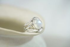 This flowing Sterling Silver ring boasts a beautiful, large Rainbow Moonstone on organically formed curves of Silver. This radiant gemstone catches the light in an array of turquoise hues, a truly unique statement piece sure to catch everyone's eye.  The ring measures 15mm wide face up and the back of the band is 4mm wide. Designed in our Devon studio, our rings are handcrafted with the utmost care and come packaged in our Isla Silver gift box, adding a touch of luxury and making them the perfec Wavy Ring, Wide Face, Silver Gift Box, Chunky Ring, Chunky Rings, Ring Unique, Ring Gemstone, Moonstone Ring, Ring Sterling Silver