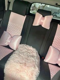 the interior of a car with pink and black bows on it's headrests