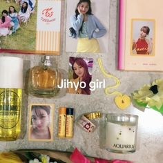 a table topped with pictures and perfumes next to flowers