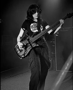 black and white photograph of a man playing bass guitar