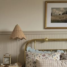 a bed sitting next to a lamp on top of a table