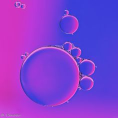 an image of bubbles in the water on a blue and pink background with space for text