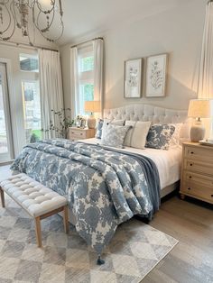 a bedroom with a large bed and chandelier