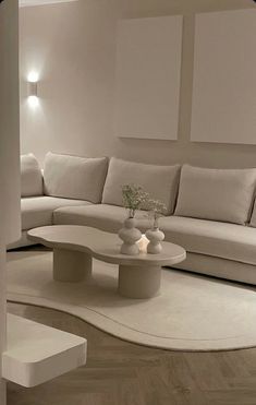 a modern living room with white furniture and wood flooring