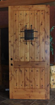 a wooden door with iron bars on it