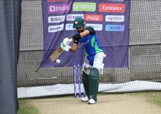 a man hitting a ball with a cricket bat