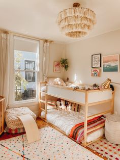 a bedroom with two bunk beds and a rug on the floor in front of a window