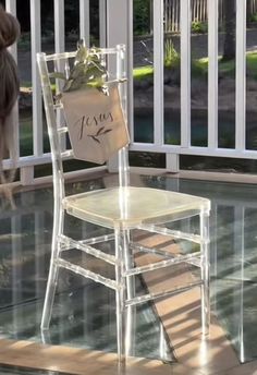 a white chair sitting on top of a glass floor