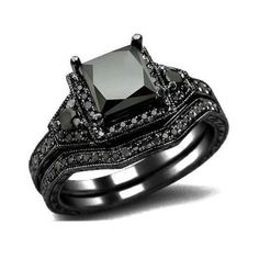 a black diamond wedding ring set on top of each other with diamonds around the band