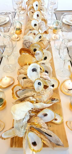 the table is set with oysters and wine glasses