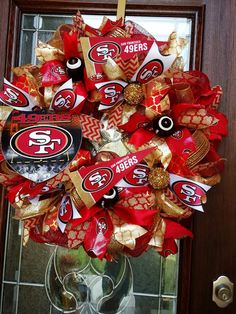 the wreath is decorated with san francisco giants footballs and gold foil letters on it