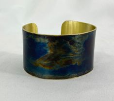 These unique, hand-formed copper and brass cuff bracelets with vibrant patinas create stunning accents to your personal style. Dress up or down- either way you'll be wearing an adornment that will turn heads, start conversations, and delight the eye of the beholder. This is a customizable brass cuff with a beautiful Torch Blue patina. Choose widths of 1-3/4"-2". Sizes: Small= 6-6-3/8", Medium: 6.5-6-3/4", Large=7-7.5". Use a fabric tape to measure the circumference of your wrist to judge your si Brass Cuff Bracelet, Eye Of The Beholder, Brass Cuff, Fabric Tape, Copper And Brass, How To Make Notes, The Eye, Natural Oils, Custom Items