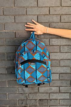 Blue African Print Bag, African Print Backpack, Funky Backpack Super colourful African print backpack made from blue and orange ankara cloth. This high-quality backpack is the perfect size for a laptop and books with two front zipped compartments for all your little things. It would also be the ideal school bag for kids who love colour!  - Vibrant African fabric - Lined for extra strength  - Two front pockets and main compartment - Adjustable straps - Made from cotton fabric - Machine washable S Ankara School Bag, Blue Backpack Shoulder Bag For School, Blue Standard Backpack Shoulder Bag For School, Blue Large Capacity Backpack For Travel, Large Capacity Blue Backpack For Travel, Blue Backpack For Students, Blue Rectangular Backpack For Students, Blue Backpack With Zipper For Daily Use, Blue Backpack For Daily Use With Zipper Closure