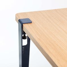 a close up of a wooden table with metal legs