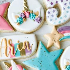 decorated cookies are arranged in the shape of stars and unicorns, including one that says dream