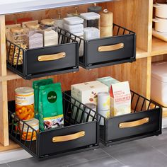 three black bins filled with food on top of a kitchen counter next to a sink