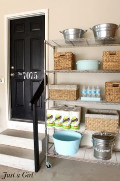 a garage shelving unit with baskets and buckets on the bottom shelf next to it