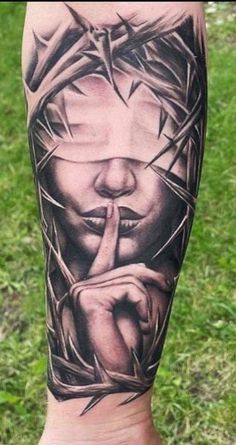 a man's leg with a tattoo on it that has the image of jesus holding a