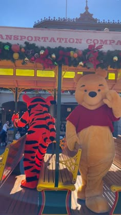 winnie the pooh and tigger on top of a carousel