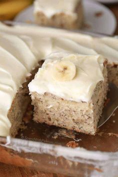 a banana cake with white frosting and sliced bananas