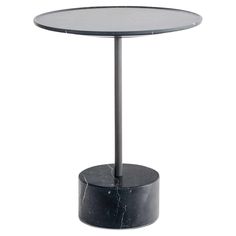 a round table with a black base and marble top on an isolated white background for display