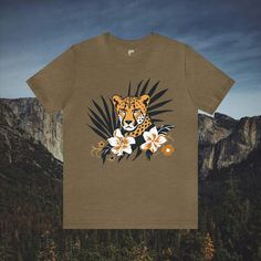 Immerse yourself in the beauty of nature with our Cheetah in Brush Wildflowers T-Shirt. This tastefully designed shirt features a cheetah amidst lush brush and wildflowers, offering a stylish and nature-inspired look. Available in a wide array of colors and sizes, this t-shirt is the perfect choice for those seeking a distinctive and elegant addition to their wardrobe. #7 Animal Classic unisex jersey short sleeve tee fits like a well-loved favorite. Soft cotton and quality print make users fall in love with it over and over again. Ribbed knit collars to bolster shaping. Shoulders are tapered for a better fit over time. Dual side seams hold the garment's shape for longer. Fabric Details Made with 100% Airlume combed and ring-spun cotton, a lightweight fabric (4.2 oz/yd² (142 g/m²)) that is Nature-inspired Summer Tops With Plant Print, Summer Nature-inspired Tops With Plant Print, Nature-inspired Tops With Plant Print For Summer, Spring Tropical Print Graphic Tee, Nature-inspired T-shirt With Plants Print For Summer, Nature-inspired Summer T-shirt With Plant Print, Spring Graphic Tee With Tropical Print, Graphic Tee With Tropical Print For Spring, Nature-inspired Graphic Print Crew Neck Top