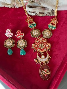 Elevate your style with our premium pendant necklace set. Crafted to perfection, this set exudes timeless beauty and unmatched quality, ensuring you stand out on every occasion. Product Details: Material: Crafted from high-quality brass, copper, dual tone plating, stones, beads, enamelled work, Kundan embellishments, this necklace boasts enduring quality and a radiant finish. Necklace Dimensions: Weight: 80 grams Drop Length: 12 inches. Closure Type: Hook Adjustable Size: Yes Earring Details: Weight (Per Pair): 32 grams. Length: 7 cm Width: 3 cm Closure Type: Push Back Closure with Extra support clip at the back. Unparalleled Craftsmanship: Our artisans have poured their skill and passion into creating a set that will leave admirers in awe. Compliment Magnet: Be prepared for a shower of co Fusion Style Jewelry Sets With Pendant For Celebration, Fusion Style Pendant Jewelry Sets For Celebration, Elegant Meenakari Round Pendant Jewelry, Elegant Dual-tone Kundan Necklace Gift, Heavy Fusion Style Formal Necklaces, Fusion Meenakari Jewelry Sets For Gift, Fusion Style Meenakari Jewelry Sets As Gift, Fusion Style Dual-tone Jewelry Sets As Gift, Fusion Dual-tone Jewelry Set For Gift