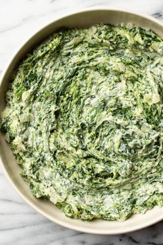 spinach dip in a bowl on a marble table