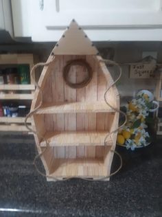 a wooden boat shaped shelf sitting on top of a counter