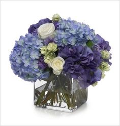 a vase filled with purple and white flowers