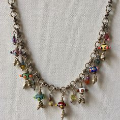 This Charm Necklace has Seven colorful Czech beads that are joined by ten of my treasure charms on a gorgeous hand made Silver Tribal Chain. This Artisan Necklace is whimsical and full of joy! A Boho Tribal Necklace, this beauty makes a bold statement. Treasure charms have beads, crystals, silver and pearls. Necklace measures 16 inches.  One of a kind! Charm Necklace, Silver Charm Necklace, Czech Glass Necklace, Artisan Necklace, Statement Necklace, Boho Necklace, Boho Jewelry Bohemian Sterling Silver Charm Necklace, Silver Bohemian Charm Necklaces With Dangling Charms, Artisan Dangle Charms Jewelry, Silver Charm Necklace With Dangling Charms, Bohemian Silver Czech Glass Necklaces, Unique Silver Charm Necklace With Dangling Charms, Bohemian Silver Necklace With Czech Glass, Bohemian Silver Czech Glass Jewelry, Bohemian Czech Glass Silver Jewelry