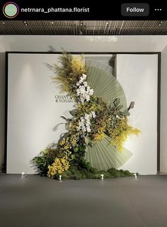 an art installation with flowers and leaves on display