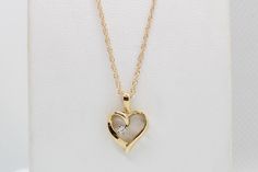 "Experience the enduring charm of our 14K Yellow Gold Heart Pendant, adorned with .03 carats total weight of Lab Diamonds, and complete with an 18\" Chain. This exquisite piece is skillfully handcrafted by our artisanal goldsmith at Jewelry By You." 14k Gold Heart Pendant Diamond Necklace For Anniversary, Yellow Gold Heart Pendant Necklace With Diamonds, Yellow Gold Open Heart Diamond Necklace, Classic Heart Cut Birthstone Necklace, Classic Diamond Cut Open Heart Necklace, Yellow Gold Diamond Necklace With Brilliant Cut Open Heart, Classic 14k Gold Heart Pendant Jewelry, Yellow Gold Heart Pendant Diamond Necklace With Brilliant Cut, Yellow Gold Brilliant Cut Heart Pendant Diamond Necklace