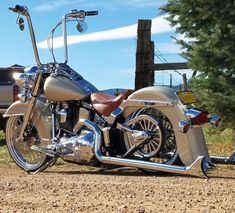 a motorcycle parked on the side of a dirt road