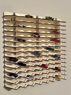 a wall mounted rack with cars on it