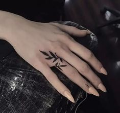 a woman's hand with a small tattoo on it