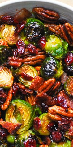 brussel sprouts with pecans and cranberries in a white bowl