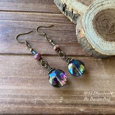 Crystal earrings boho rainbow tourmaline handmade purple round dangle bronze boho style festival gift her unique jewelry earrings for women Earrings for women. Yes, please. I love to rock a great pair of earrings. Stone, crystal, lampwork, beaded earrings, well I love all of them! These earrings have 18mm rainbow crystal faceted round drops, 6mm tourmaline gemstone, 4mm Swarovski Crystal aurora beads, bronze findings and ear wire. Can't find your stone or color? I specialize in hard to find uniq Bohemian Iridescent Jewelry For Jewelry Making, Iridescent Round Bohemian Jewelry, Bohemian Iridescent Round Jewelry, Purple Bohemian Crystal Earrings As A Gift, Bohemian Iridescent Jewelry With Ear Wire, Purple Bohemian Crystal Earrings For Gift, Handmade Bohemian Crystal Earrings, Handmade Purple Bohemian Crystal Earrings, Handmade Bohemian Purple Crystal Earrings