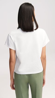 Made of midweight Portuguese cotton, this classic shrunken style features a crew neck, above-the-elbow sleeve, and slim-fit silhouette. The super-soft fabric melts against the skin, making it the essential layering piece. Wear under suiting or shirting, or go the more casual route with shorts and an oversized cardigan. Simple Boxy Fit Crew Neck Top, Simple Boxy Crew Neck Top, Simple Organic Cotton Crew Neck Top, Simple Cotton Tops With Boxy Fit, Classic Boxy Fit Crew Neck Top, Solid Color Cotton Tops With Straight Hem, Minimalist Boxy Fit Crew Neck Top, Solid Cotton Tops With Straight Hem, Simple Crew Neck T-shirt For Layering