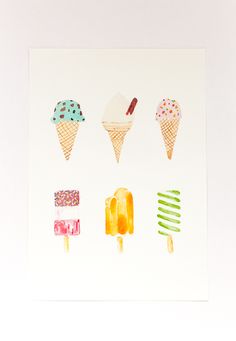 four ice creams are arranged in different colors and shapes on a white paper background