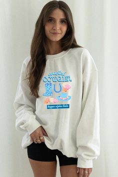 a woman wearing a white sweatshirt and black shorts with the words, donut u on it