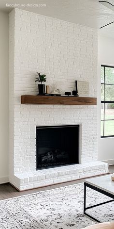 a living room with a white brick fireplace