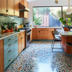 a kitchen with lots of counter space and colorful floor tiles on the walls, floors and counters