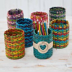 several different colored baskets with pencils in them