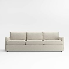 a white couch sitting on top of a white floor