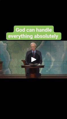 a man standing at a podium in front of a screen with the words god can handle everything