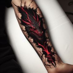 a man's arm with a red dragon tattoo on it and his leg is shown