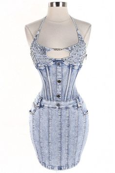 a dress made out of denim with buttons on the front and straps at the back