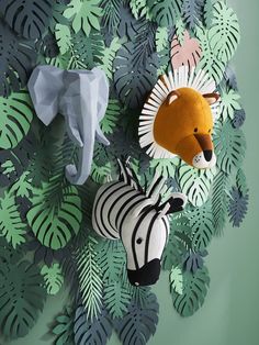 an elephant, zebra and giraffe made out of paper on a green wall